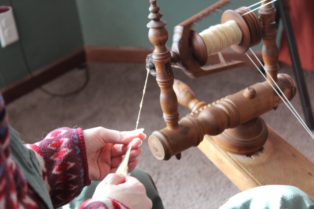 Closeup of drafting wool while spinning 
