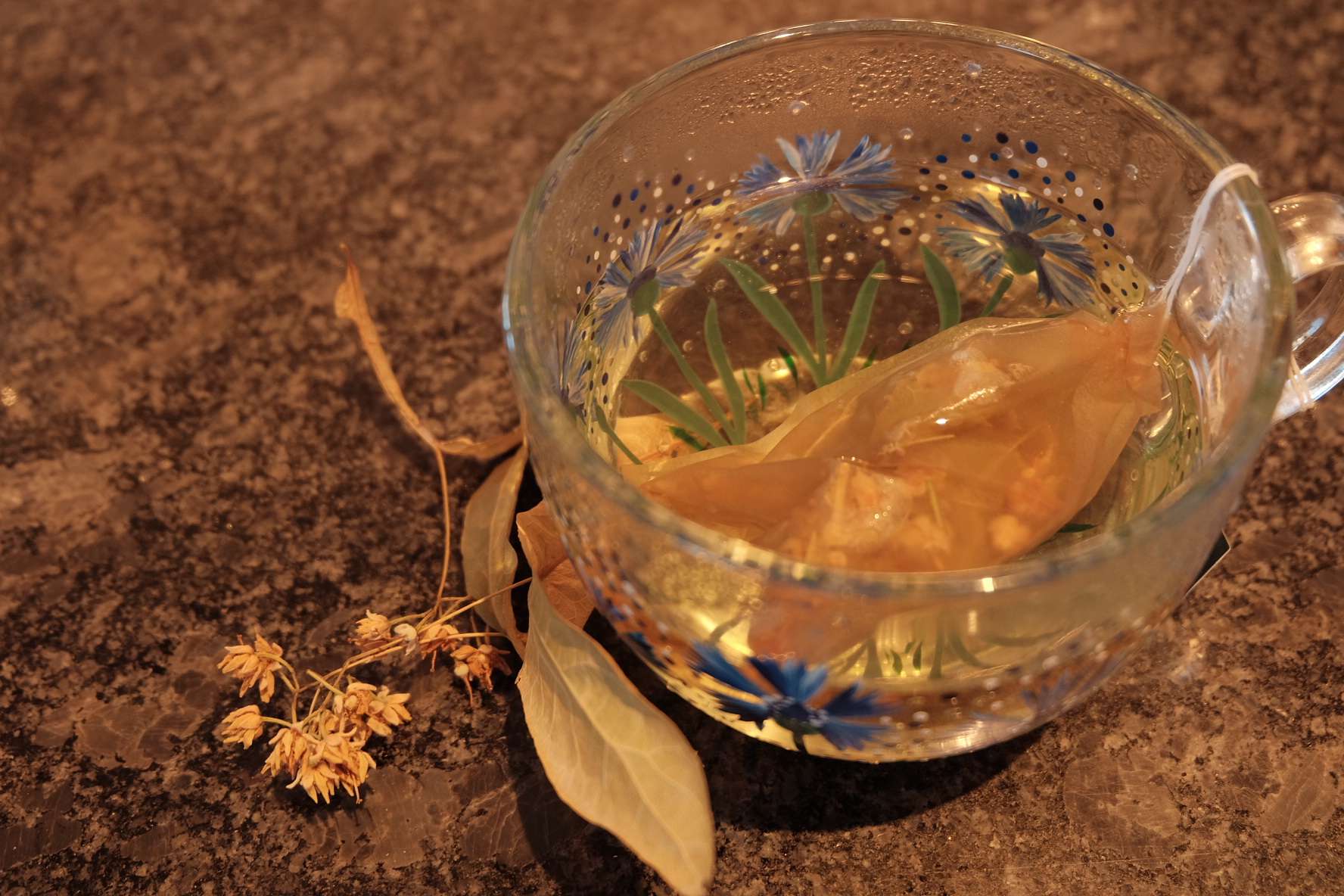 Golden cup of homemade linden tea with honey